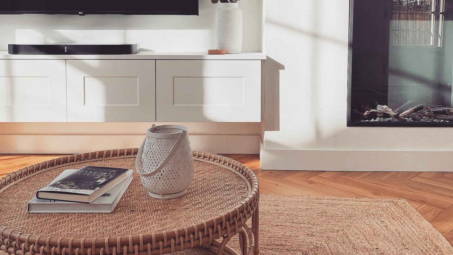 Minimal living room idea with a bespoke, wall-hung TV unit made from white, shaker cupboard doors with a smooth finish.