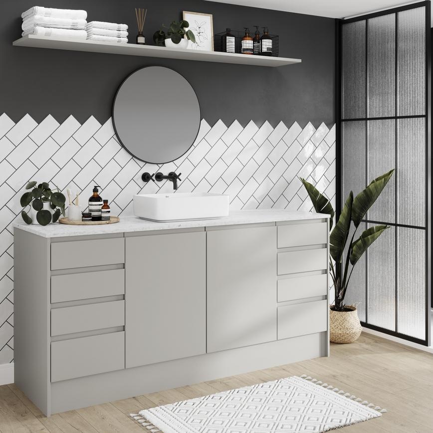 Modern bathroom in soft dove grey colour and matt finish. Features integrated handles and oak floors for a pared-back look.