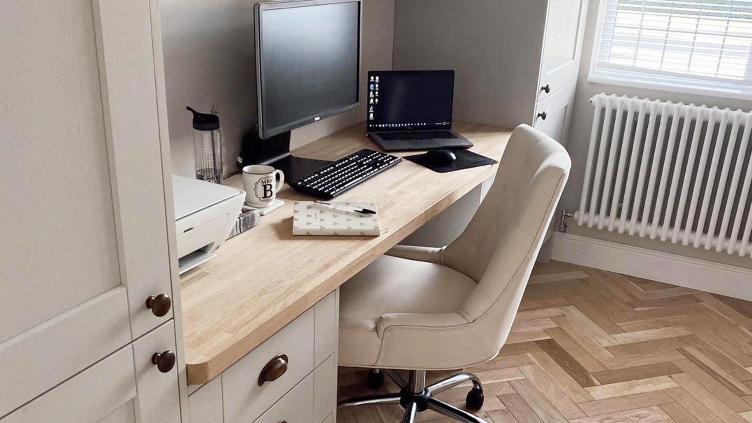 Grey home office makeover with shaker doors, light wood chevron flooring, light oak worktop, and knob handles.