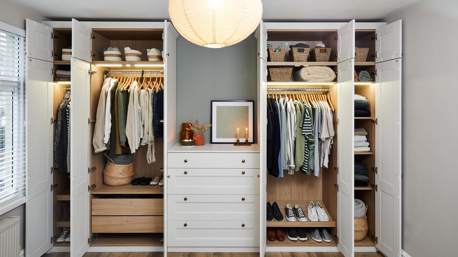 The interior of two tall white wardrobes, featuring hanging rails, internal drawers, shelving, and shoe storage.