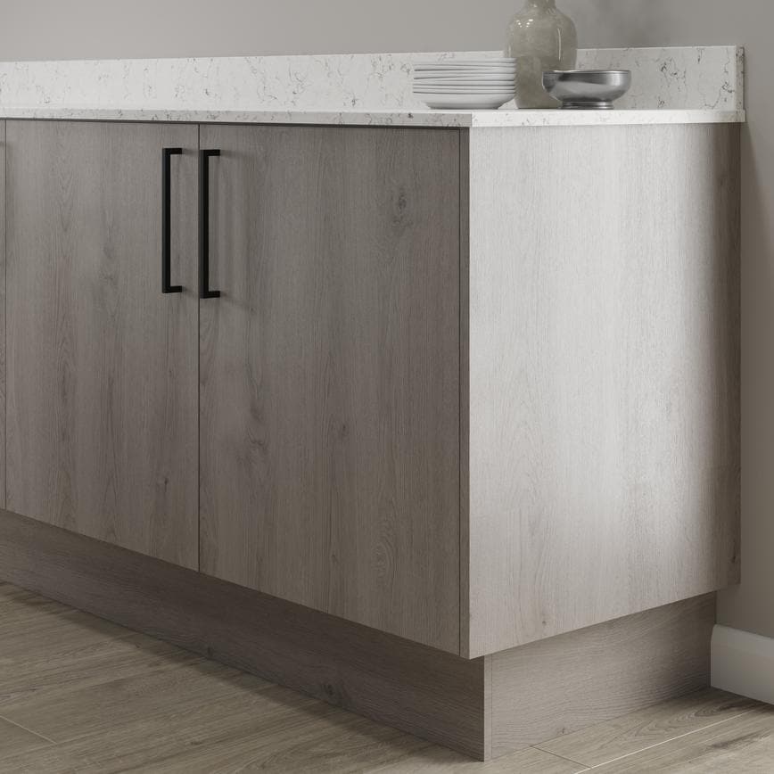 Light grey oak continuous plinth fitted with base cabinet and white worktop