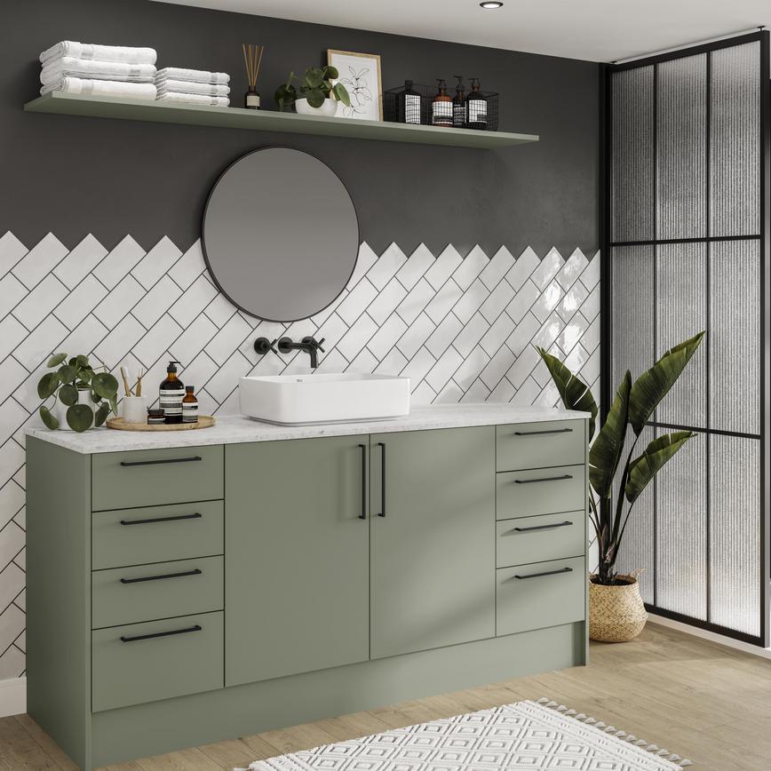 Reed green bathroom with slab doors and matt finish for a modern design. Includes oak-effect flooring and slim black handles.